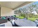 Covered patio with outdoor seating and a view of the backyard at 14672 Horse Trot Rd, Lithia, FL 33547
