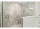 Modern bathroom shower with gray tile and glass door at 14672 Horse Trot Rd, Lithia, FL 33547