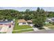 Aerial view of a home with a big green lawn and convenient covered carport at 2017 Waikiki Way, Tampa, FL 33619