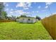 Large grassy backyard features a new wood fence for added privacy at 2017 Waikiki Way, Tampa, FL 33619