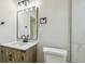 Clean, modern bathroom showcasing a black framed mirror, vanity, and updated fixtures at 2017 Waikiki Way, Tampa, FL 33619