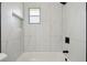 Modern bathroom featuring stylish marble tile, a shower, and a bright window at 2017 Waikiki Way, Tampa, FL 33619