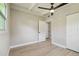 Bright bedroom with wood floors, ceiling fan, white trim, and an open closet at 2017 Waikiki Way, Tampa, FL 33619