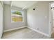 Bright bedroom with beamed ceiling, closet and view to fenced backyard at 2017 Waikiki Way, Tampa, FL 33619