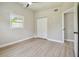 Spacious, bright bedroom with new floors, a ceiling fan, and closet at 2017 Waikiki Way, Tampa, FL 33619