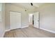 Bright bedroom featuring new wood floors, ceiling fan, closet, and access to the bathroom at 2017 Waikiki Way, Tampa, FL 33619