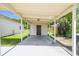 Spacious covered carport with access door to the backyard at 2017 Waikiki Way, Tampa, FL 33619