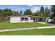 Beautiful home featuring a large manicured front yard and a convenient covered carport at 2017 Waikiki Way, Tampa, FL 33619