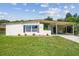 Charming single-story home with a covered carport, neat landscaping, and freshly cut green grass at 2017 Waikiki Way, Tampa, FL 33619