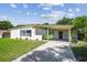 Charming single-story home with a covered carport, neat landscaping, and freshly cut green grass at 2017 Waikiki Way, Tampa, FL 33619