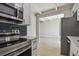 View of the kitchen to the living room with stainless steel appliances and sleek countertops, creating a modern flow at 2017 Waikiki Way, Tampa, FL 33619
