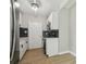 Clean kitchen featuring white cabinets, stainless steel appliances, dark backsplash, and updated lighting at 2017 Waikiki Way, Tampa, FL 33619