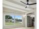 Open living room with ceiling beams, large window offering natural light, and flows into the modern kitchen at 2017 Waikiki Way, Tampa, FL 33619