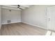 Light-filled living space featuring durable floors, fresh paint, and a ceiling fan at 2017 Waikiki Way, Tampa, FL 33619