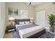 Well-lit main bedroom with decor, stylish rug, closet, and a bright window at 2017 Waikiki Way, Tampa, FL 33619