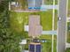 Aerial view of a single-Gathering home featuring a well-maintained lawn and a driveway with parking space at 2027 Balfour Cir, Tampa, FL 33619