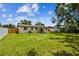 The backyard is spacious and well-maintained, featuring a pristine lawn, privacy fencing and a covered patio area at 2027 Balfour Cir, Tampa, FL 33619