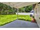 Spacious backyard featuring a well-maintained lawn, white vinyl fence, and a covered patio perfect for outdoor relaxation at 2027 Balfour Cir, Tampa, FL 33619