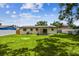 This backyard is expansive and features a lush green lawn, complete with a covered patio and privacy fence at 2027 Balfour Cir, Tampa, FL 33619