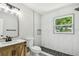 Modern bathroom features marble-style tiling, stylish fixtures, and a contemporary design at 2027 Balfour Cir, Tampa, FL 33619