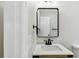 Bathroom featuring a wood vanity with a white countertop, black faucet and framed mirror at 2027 Balfour Cir, Tampa, FL 33619