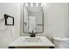Well-lit bathroom featuring a modern vanity with a unique mirror and sleek fixtures at 2027 Balfour Cir, Tampa, FL 33619