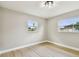 Bright room with neutral walls, two windows and light wood-look flooring at 2027 Balfour Cir, Tampa, FL 33619