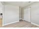 Cozy bedroom features light flooring, neutral paint, and a closet with sliding doors at 2027 Balfour Cir, Tampa, FL 33619