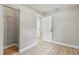 Bright bedroom featuring a spacious closet, neutral walls, and light wood-look floors at 2027 Balfour Cir, Tampa, FL 33619