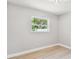 Bright bedroom features neutral paint, light flooring, and a window overlooking a serene view at 2027 Balfour Cir, Tampa, FL 33619