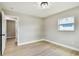 Bright bedroom with neutral walls, light flooring, and a window at 2027 Balfour Cir, Tampa, FL 33619