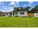 A lovely single-story house featuring a spacious green lawn and tidy landscaping at 2027 Balfour Cir, Tampa, FL 33619