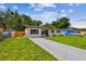 A quaint single-Gathering home featuring a freshly mowed lawn and a concrete driveway at 2027 Balfour Cir, Tampa, FL 33619