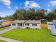 Beautiful home featuring a well-kept lawn, charming landscaping, and inviting entrance enhancing the property's curb appeal at 2027 Balfour Cir, Tampa, FL 33619