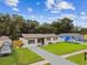 Charming single-story home with a well-manicured lawn, updated landscaping, and a welcoming entrance, showcasing curb appeal at 2027 Balfour Cir, Tampa, FL 33619