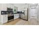 Updated kitchen with stainless steel appliances, white cabinets, and subway tile backsplash at 2027 Balfour Cir, Tampa, FL 33619