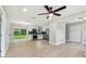 Bright and airy living space featuring open floor plan with new flooring and a modern kitchen at 2027 Balfour Cir, Tampa, FL 33619