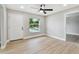 Well-lit living room features new flooring, fresh paint, and a front door at 2027 Balfour Cir, Tampa, FL 33619