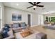 A cozy living room with a comfortable sectional, stylish coffee table, and an adjacent dining area at 2027 Balfour Cir, Tampa, FL 33619