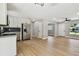 Open-concept kitchen and living room with stainless steel appliances and new flooring at 2027 Balfour Cir, Tampa, FL 33619