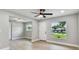 Bright and airy living room features wood-look flooring and a modern ceiling fan at 2027 Balfour Cir, Tampa, FL 33619