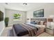 Stylishly decorated bedroom features a comfortable bed, modern lighting, and a window with a pleasant view at 2027 Balfour Cir, Tampa, FL 33619