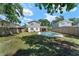 Backyard features a private pool, mature trees, and ample space for recreation and relaxation at 208 Se Lincoln N Cir, St Petersburg, FL 33703