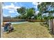 Large backyard with a fenced-in pool and well-maintained grassy area, perfect for outdoor activities at 208 Se Lincoln N Cir, St Petersburg, FL 33703