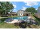 Backyard showing sparkling pool and lush lawn perfect for relaxation and outdoor activities at 208 Se Lincoln N Cir, St Petersburg, FL 33703