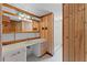 Unique bathroom featuring wood paneling and a tiled shower at 208 Se Lincoln N Cir, St Petersburg, FL 33703