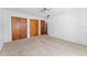 Bright bedroom featuring carpet, closet, and ceiling fan at 208 Se Lincoln N Cir, St Petersburg, FL 33703