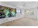Empty bedroom featuring two windows and a mural on the wall at 208 Se Lincoln N Cir, St Petersburg, FL 33703