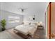 Staged primary bedroom featuring neutral decor, ceiling fan, and a closet at 208 Se Lincoln N Cir, St Petersburg, FL 33703