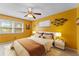 Sunny bedroom furnished with a queen bed, nightstands, and lamps at 208 Se Lincoln N Cir, St Petersburg, FL 33703
